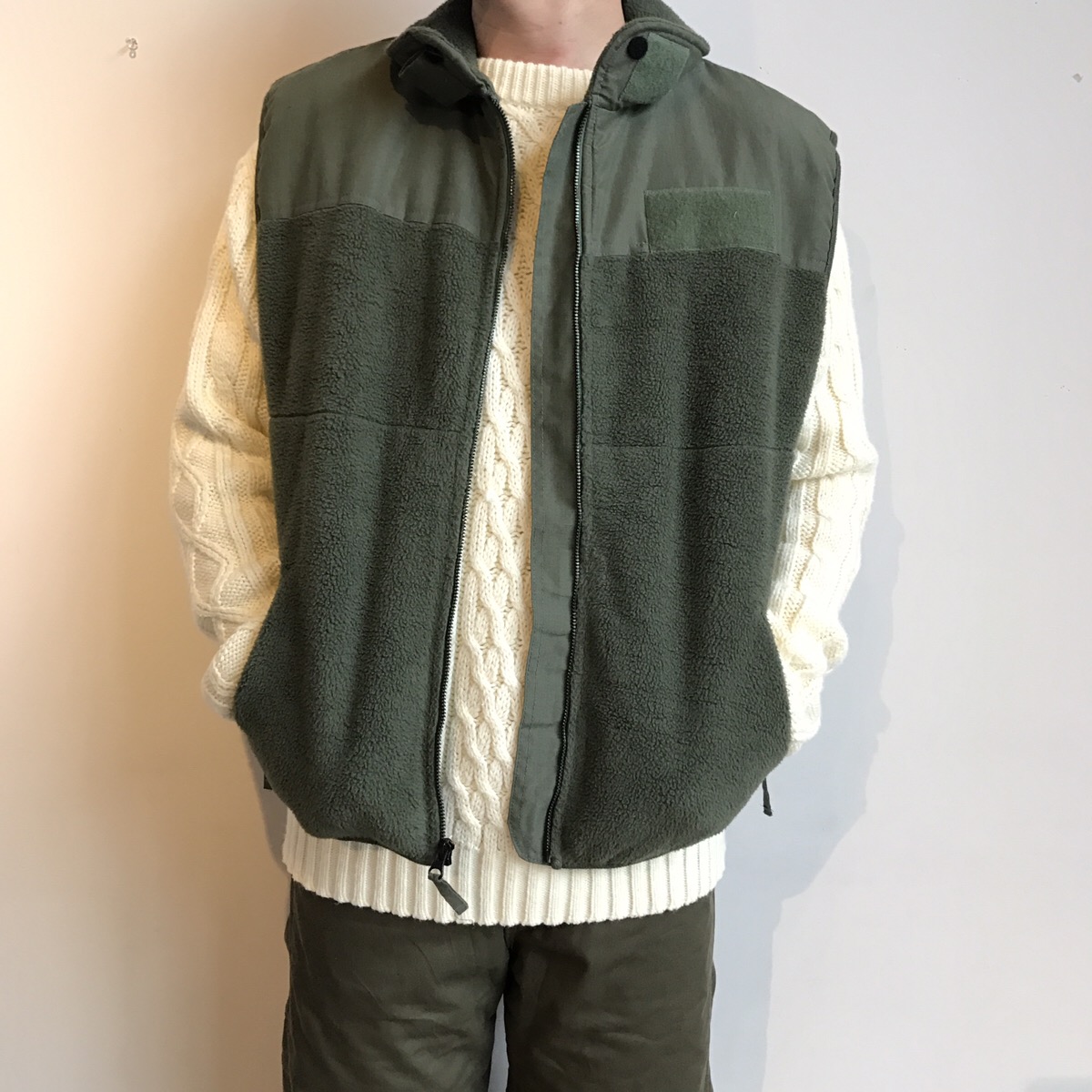 military fleece vest, cable sweater